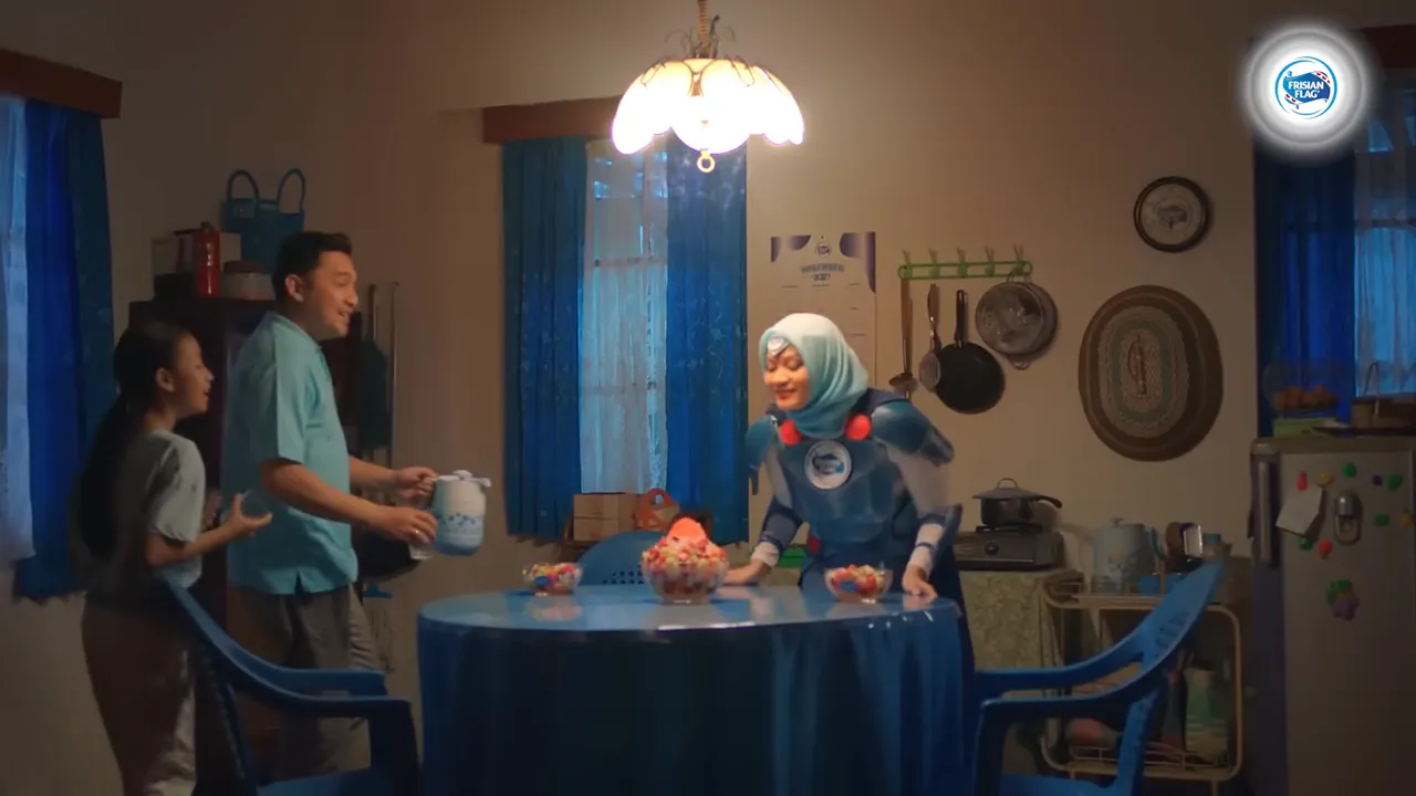 A mother in ceremonial Pejuang Kemenangan armour reaching toward a splash of milk in her kitchen