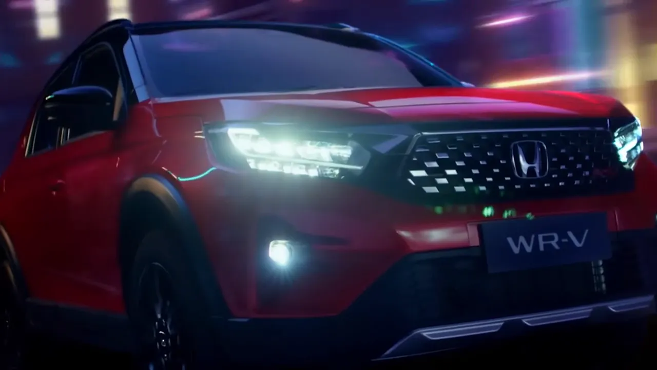Red Honda WR-V driving through a neon-lit night scene
